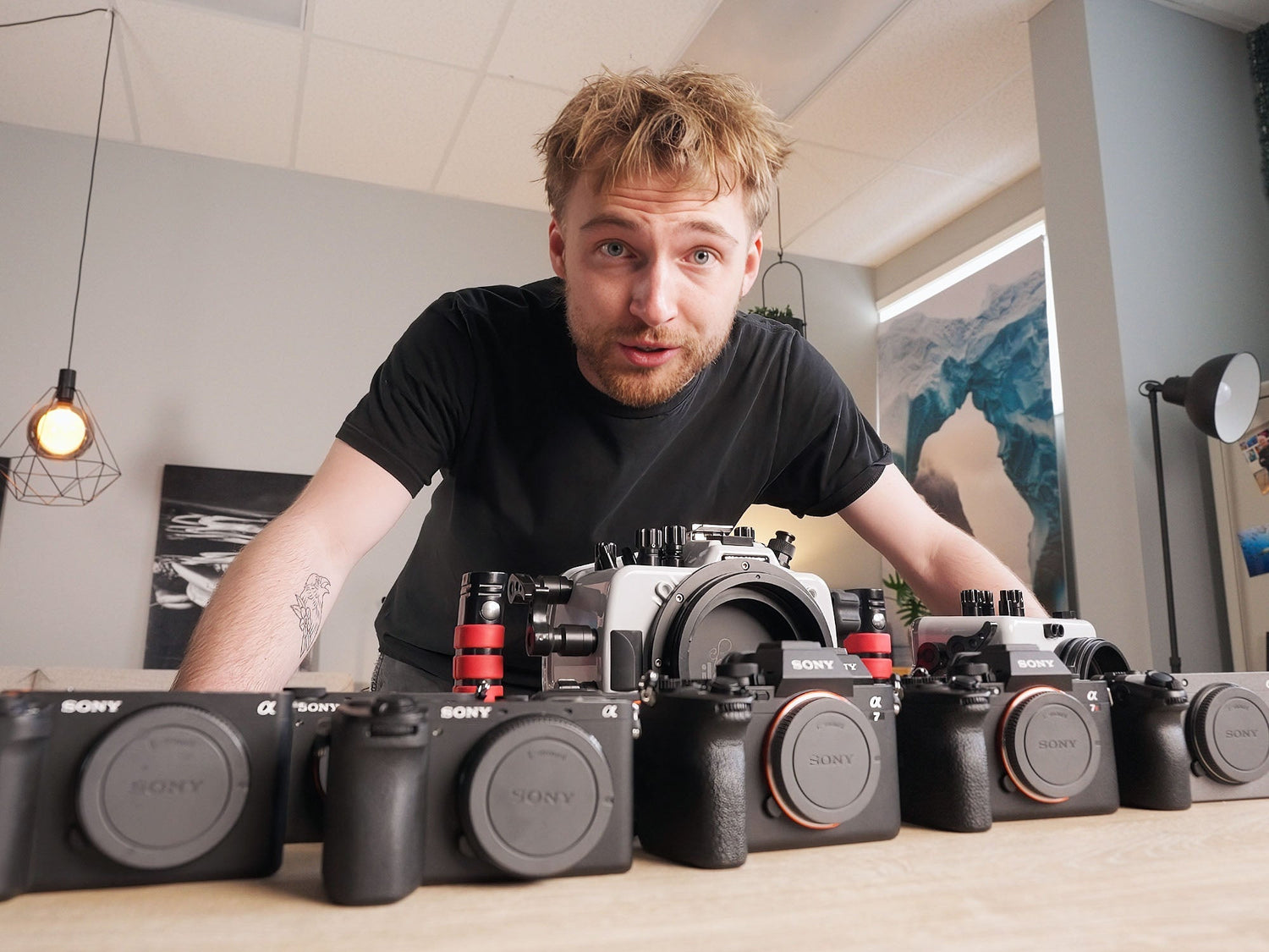 Ikelite Video Producer Logan Wood pictured with a line up of Sony Cameras