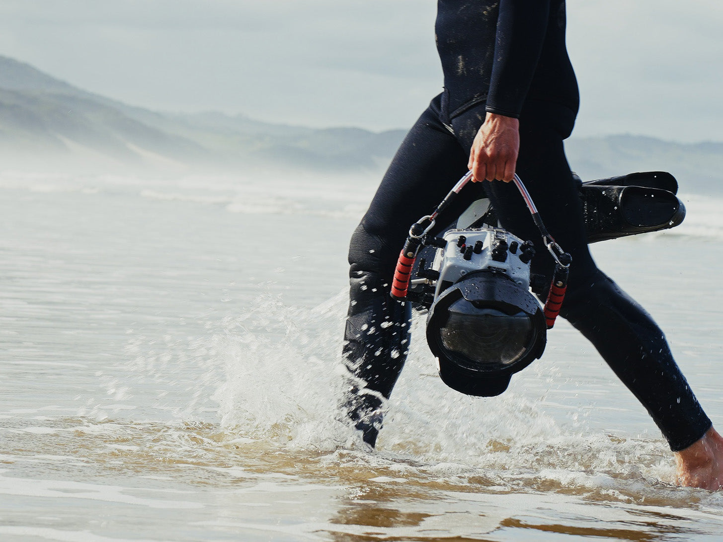 Ikelite 200DL Underwater Housing being carried through the Surf in South Africa by Ikelite Ambassador Jacques de Vos