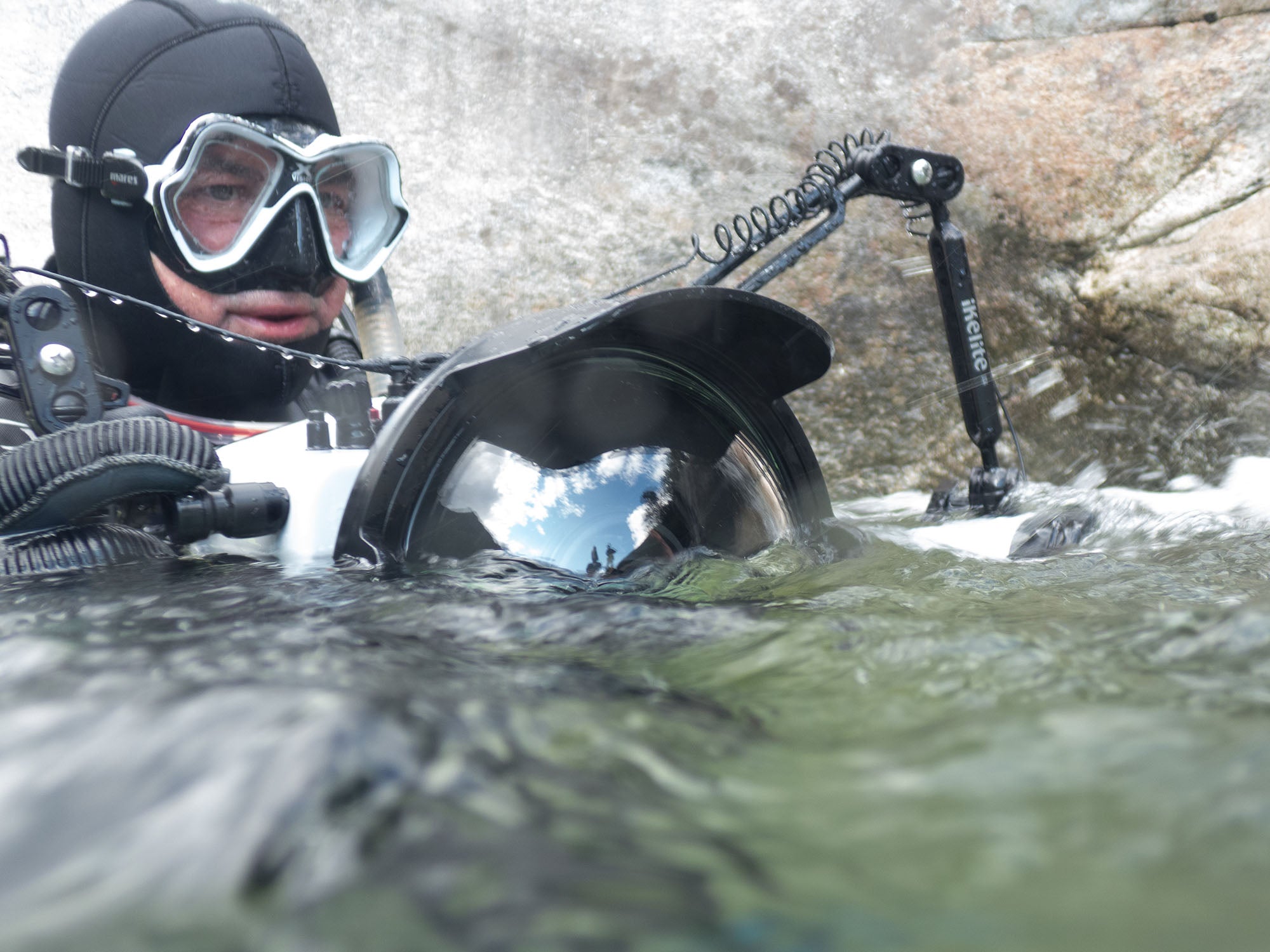 Steve Miller underwater in Verzasca Valley, Switzerland taking underwater photos with Ikelite Underwater Systems gear